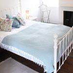 Bedroom 4 has a charming wrought iron bedstead with soft pastel linen