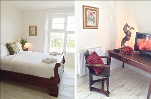 This light filled bedroom at Devon Farmhouse has a charming roll top bed and beautiful antique furniture