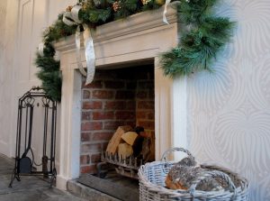 The fireplace in the dining room decorated for a big family get together at Christmas