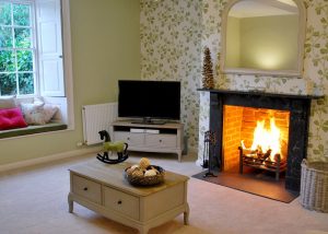 The sitting room with the log fire burning for a cosy atmosphere at a friends reunion