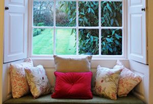 The pretty window seat in the sitting room, with an eclectic mix of cushions.