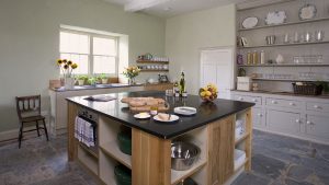 The kitchen at Berry House has a large central island, a farmhouse style dresser and plenty of equipment for a large party