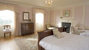 The Buck bedroom has a wooden sleigh bed and lovely antique furniture.