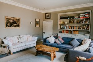 The light filled sitting room with large sofas