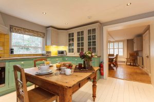 The country style kitchen and scrubbed pine table are really homely