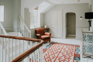 Attractive rugs and beautiful artwork adorn the house