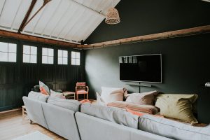 The chill out section of the games room with sofas and wide screen TV