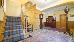 The oak panelled hall with stairs leading to 8 of the 10 bedrooms at Tatham House in Somerset