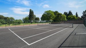 The tennis court is close to the walled garden, hot tub and indoor pool