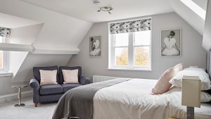 Beautiful textiles and pale paintwork in this bedroom at our big house near Cheltenham.