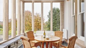 The Sun Room with large windows looking over the gardens.