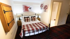 A cosy ground floor bedroom with a double bed and ensuite