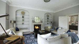 The elegant drawing room with log fire and views over the garden