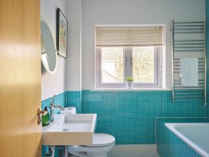 A sleek family bathroom with stunning turquoise tiles