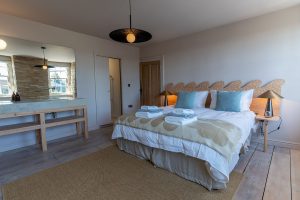 Bedroom with sink & fireplace bed angle