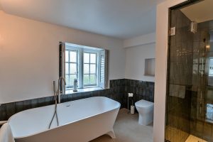 Bath to bedroom 1 in party house in the Cotswolds